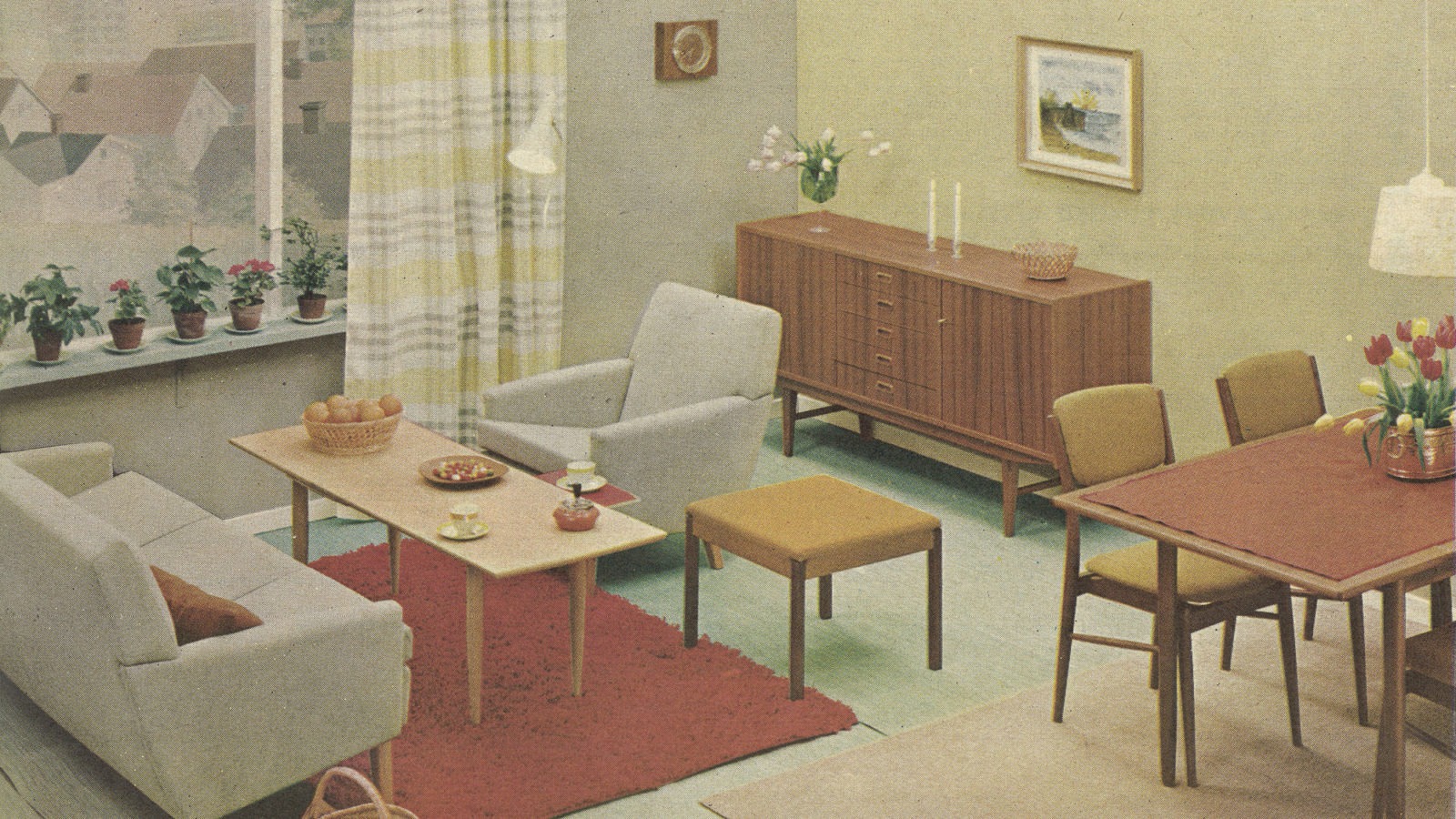 Interior in 1960s style with potted plants in window, red rug, beige sofa group, dining group and sideboard of wood.