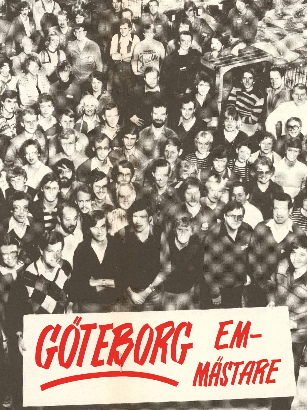 Group photo of large group of IKEA staff in 1980s clothing, behind banner saying Gothenburg, European champions.