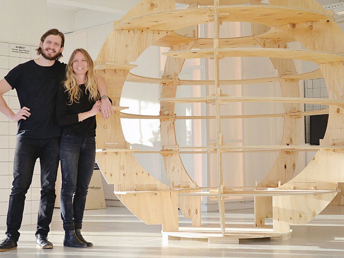 Die Architekten Mads-Ulrik Husum und Sine Lindholm neben einer Anzuchtkuppel aus unbehandeltem Sperrholz namens „Growroom“.