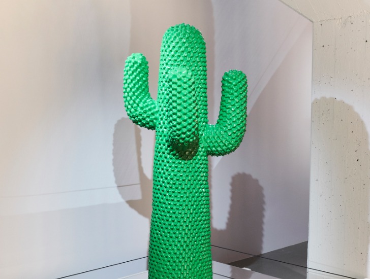En grön klädhängare som heter ”Cactus”. Klädhängaren är formad som en kaktus och skapad av mjukt men stadigt polyuretan.