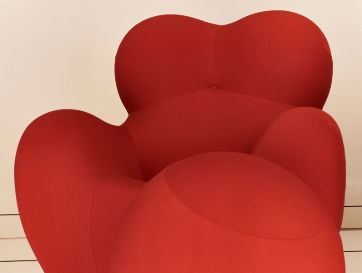 A rounded, red foam armchair called “Up” resembling an ancient fertility goddess, and a ball.