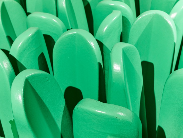 A closeup of the “Pratone” armchair consisting of a square of giant, green grass straws made from soft yet sturdy polyurethane.