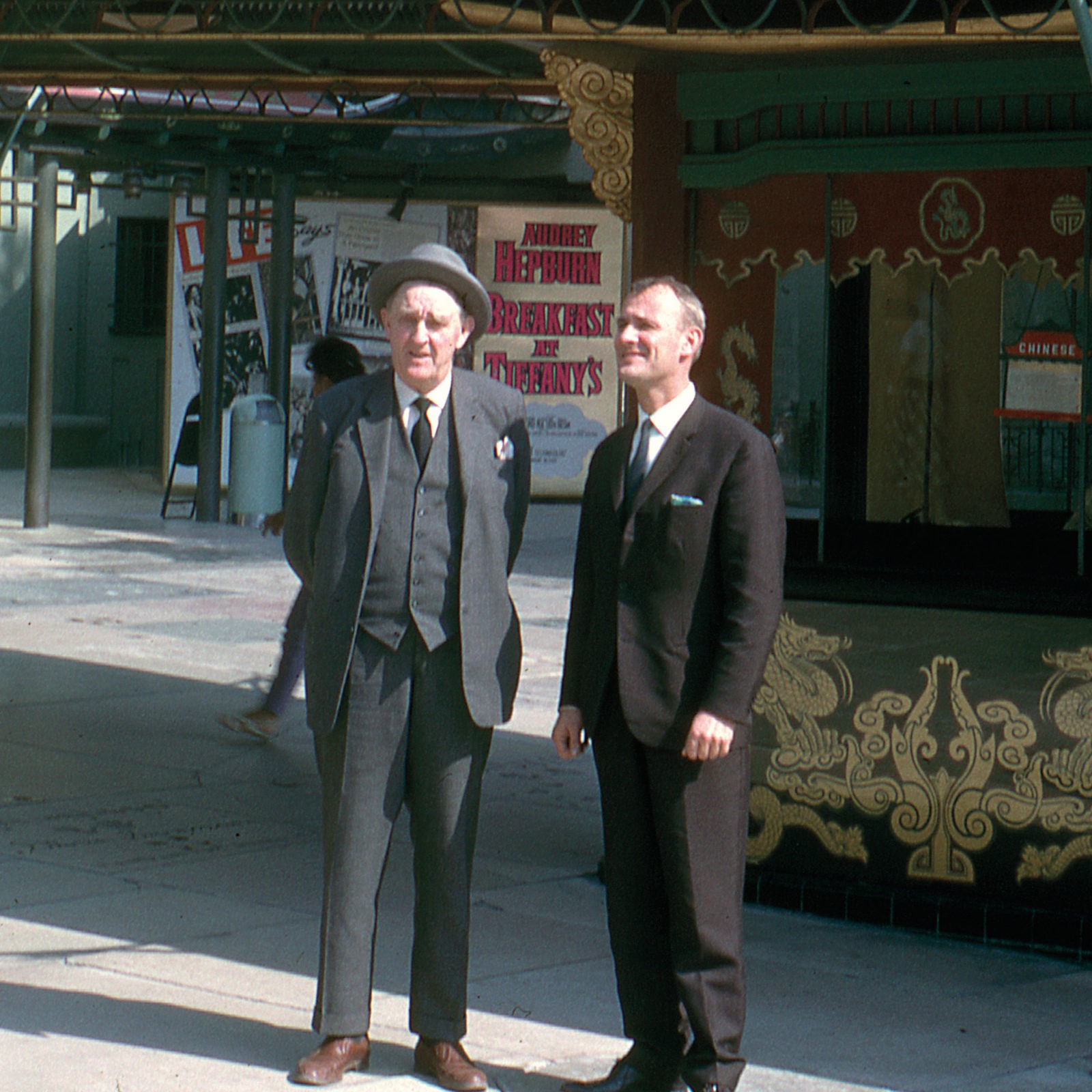 Ingvar and his father Feodor standing on a city street in dark suits and ties, squinting in the sun.