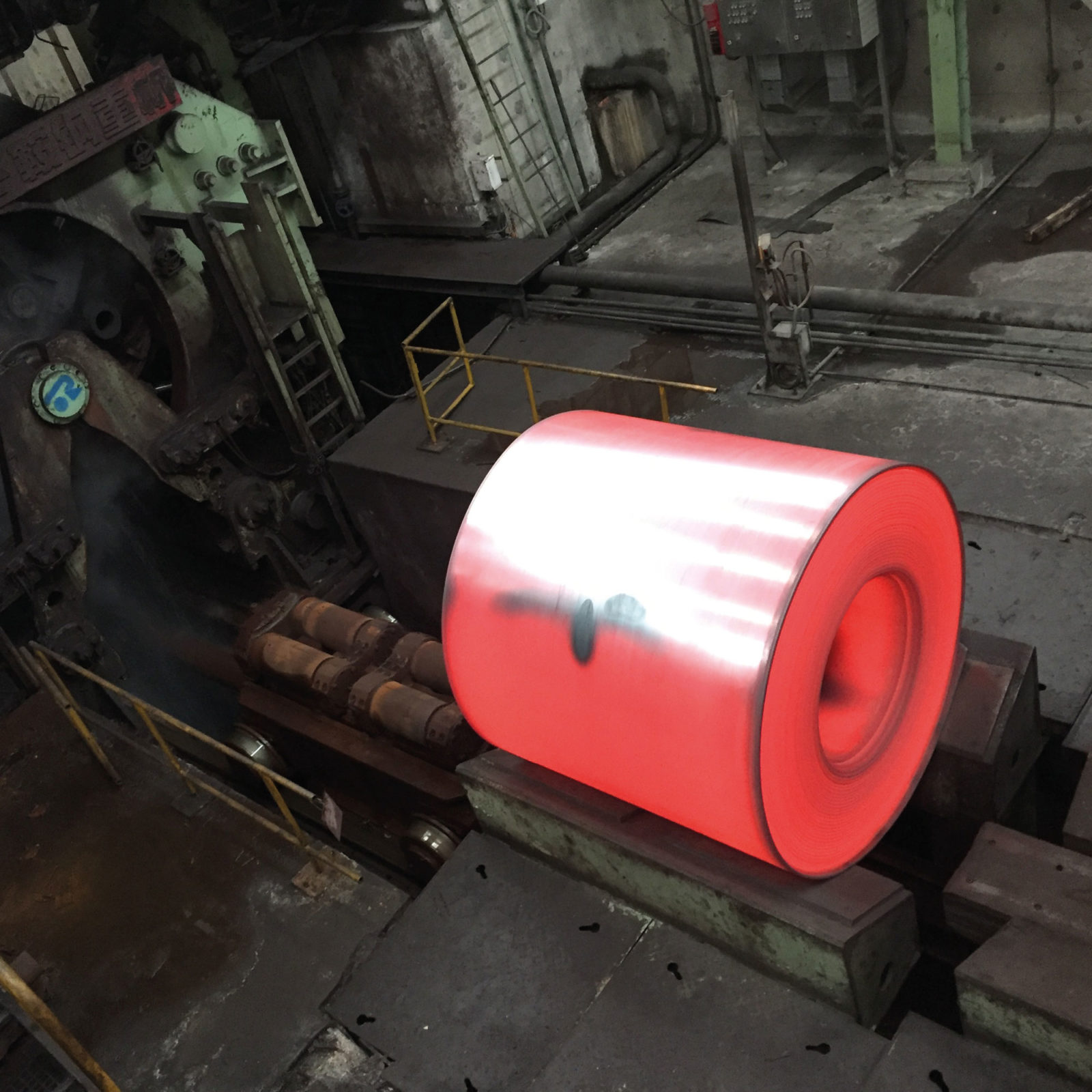 Red-hot spinning spool in industrial machine.