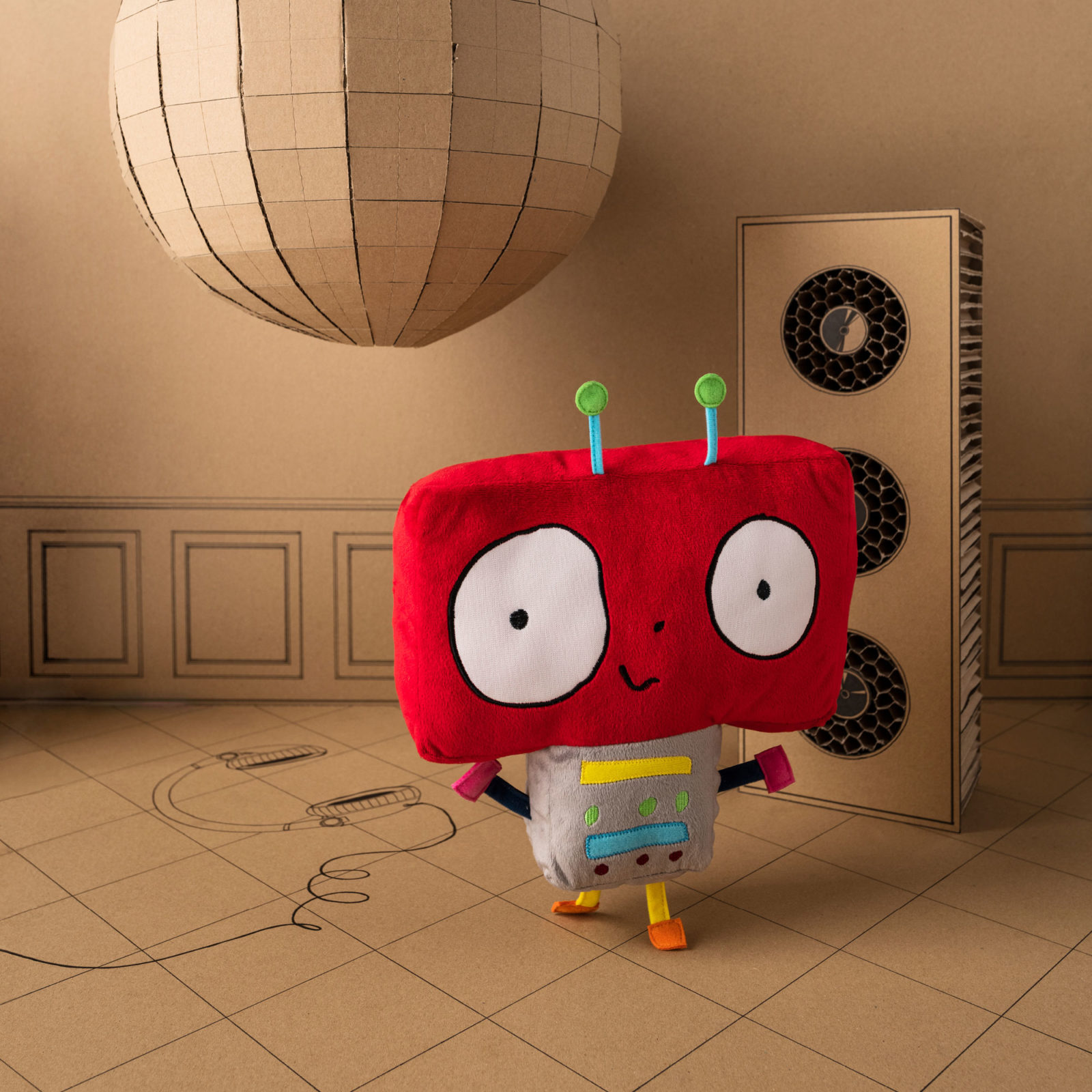 En mjuk stoppad leksaksrobot med brett rött huvud och liten kropp.