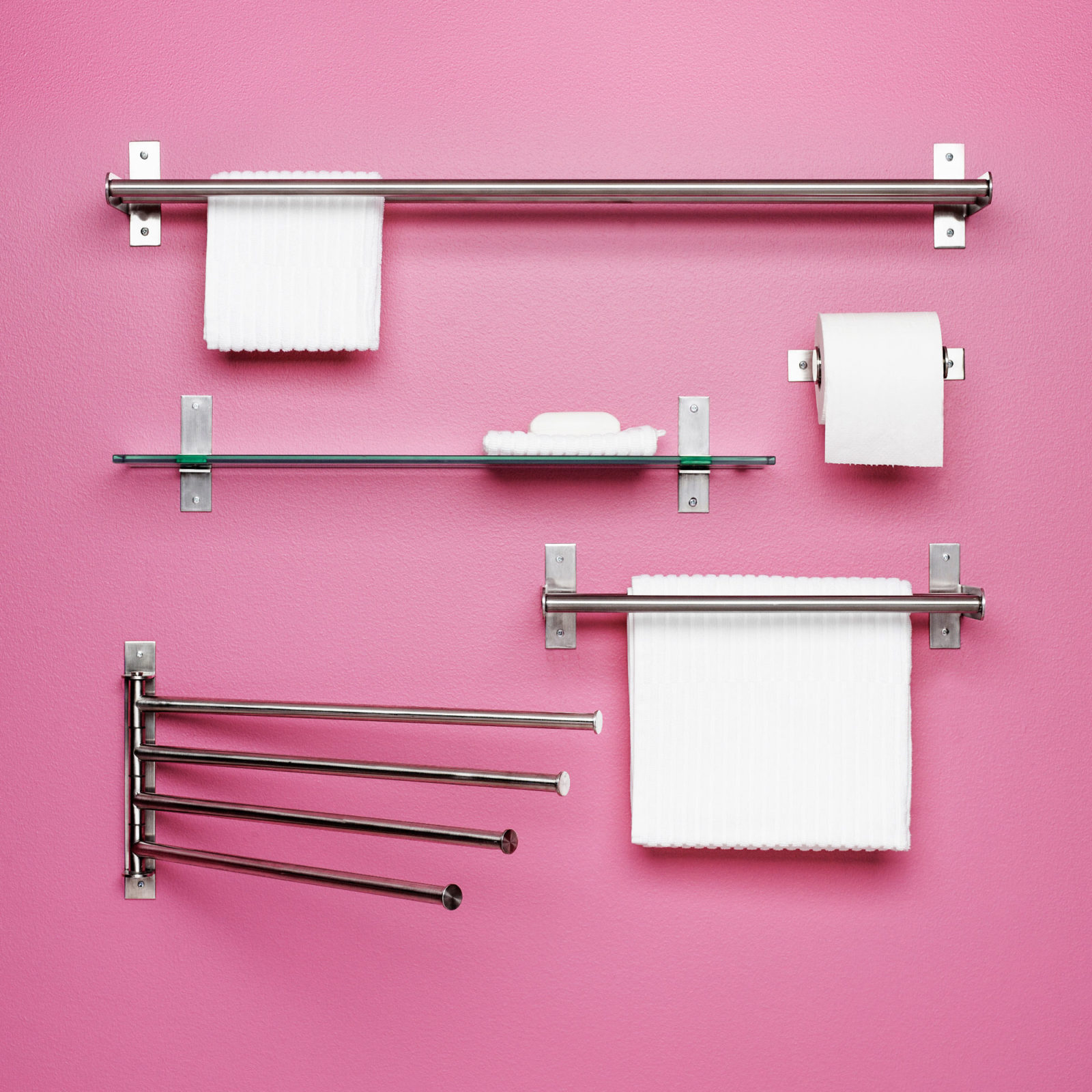 A number of stainless steel bathroom products for hanging things including toilet paper and towels.