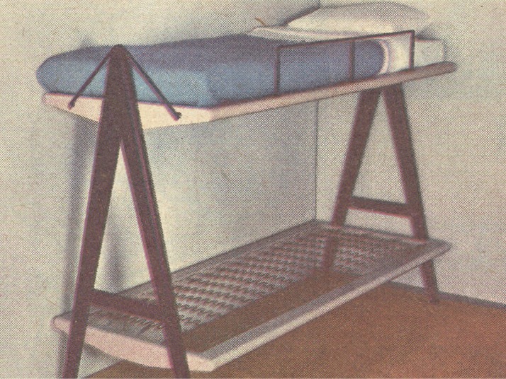 A SPORT bunk bed, with A-shaped headboards. The top bunk is neatly made, the bottom has no mattress or linen.