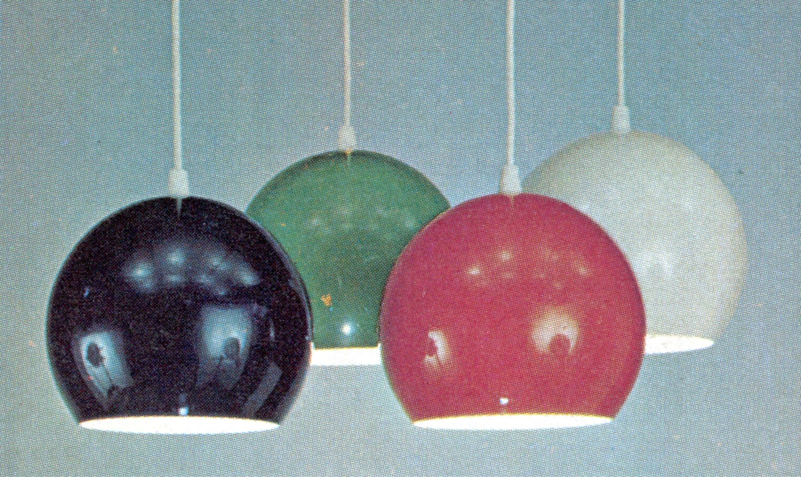 Four spherical lamps in different colours, black, green, red and white, hanging from ceiling, KLOT.