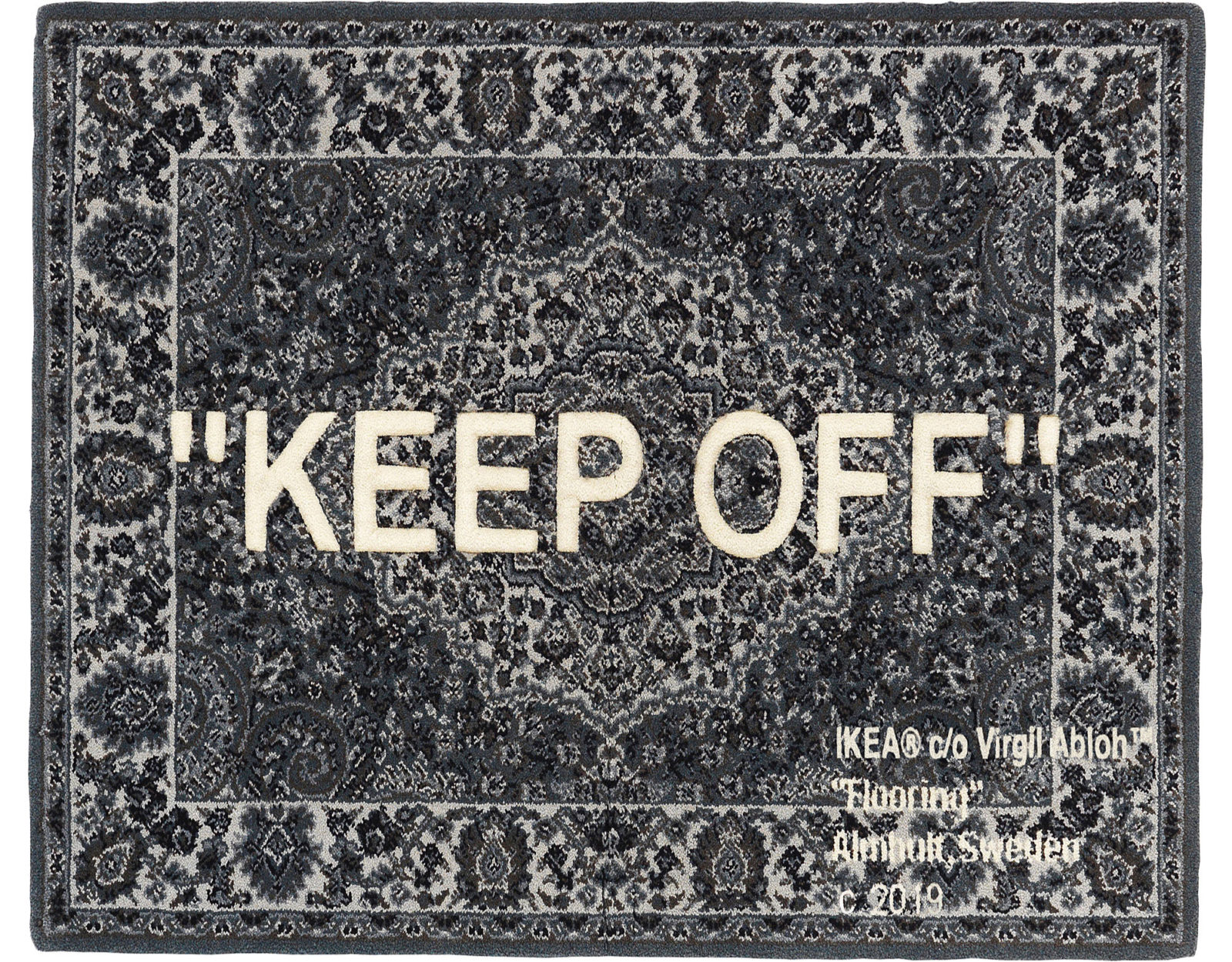 Grey rug, pattern inspired by Persian rugs, large white text across says, in capital letters, 'Keep off'.