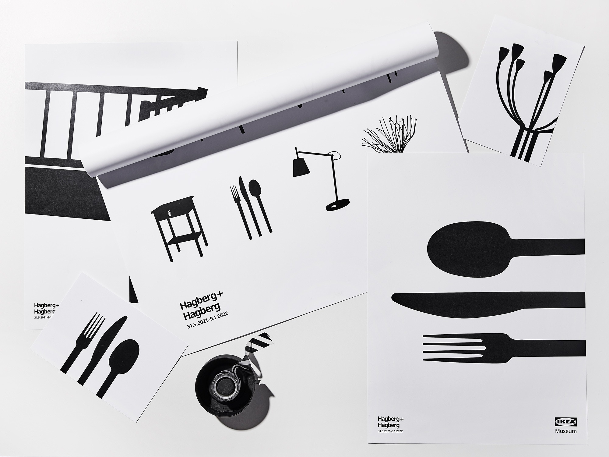 Posters and postcards with black and white stylised pattern with silhouettes of home furnishing products.