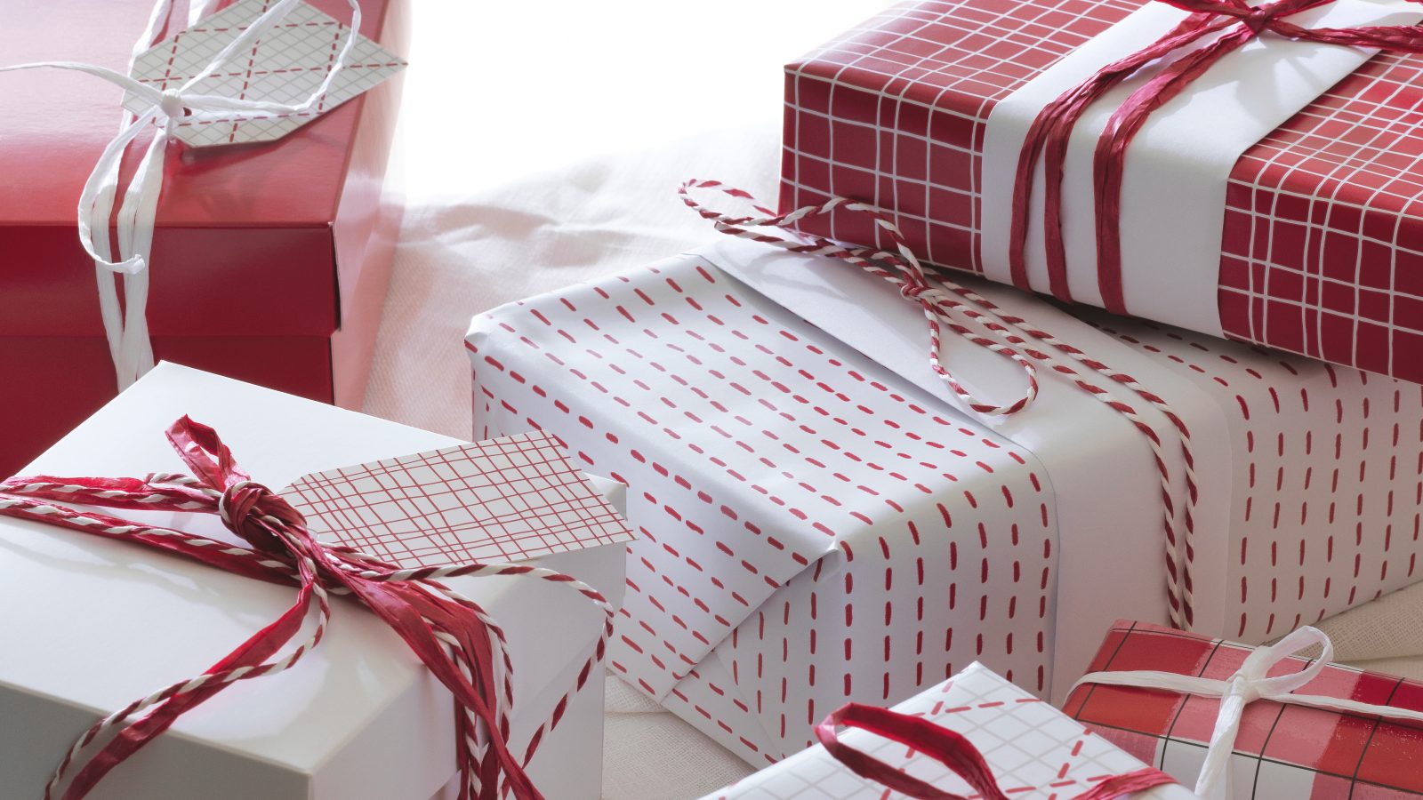 Wrapped Christmas presents with red and white gift wrap.