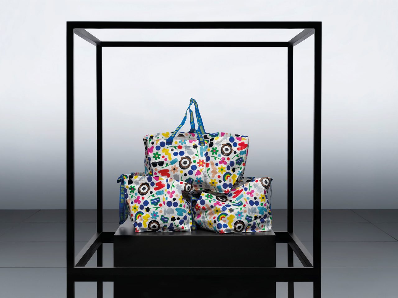 Three plastic tote bags of different sizes with a colourful pattern.