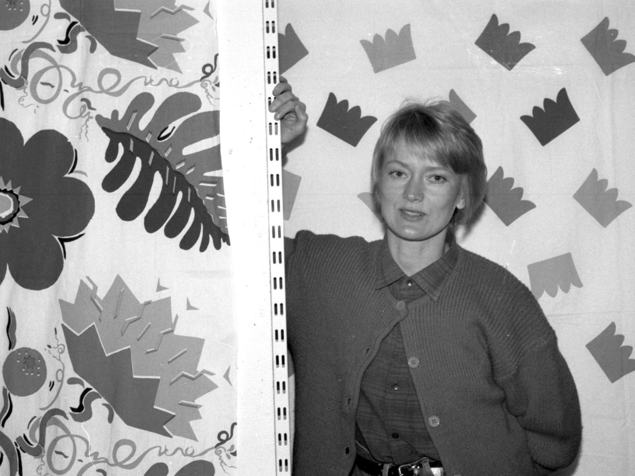 Yvonne Andersson in front of bold patterned fabrics.
