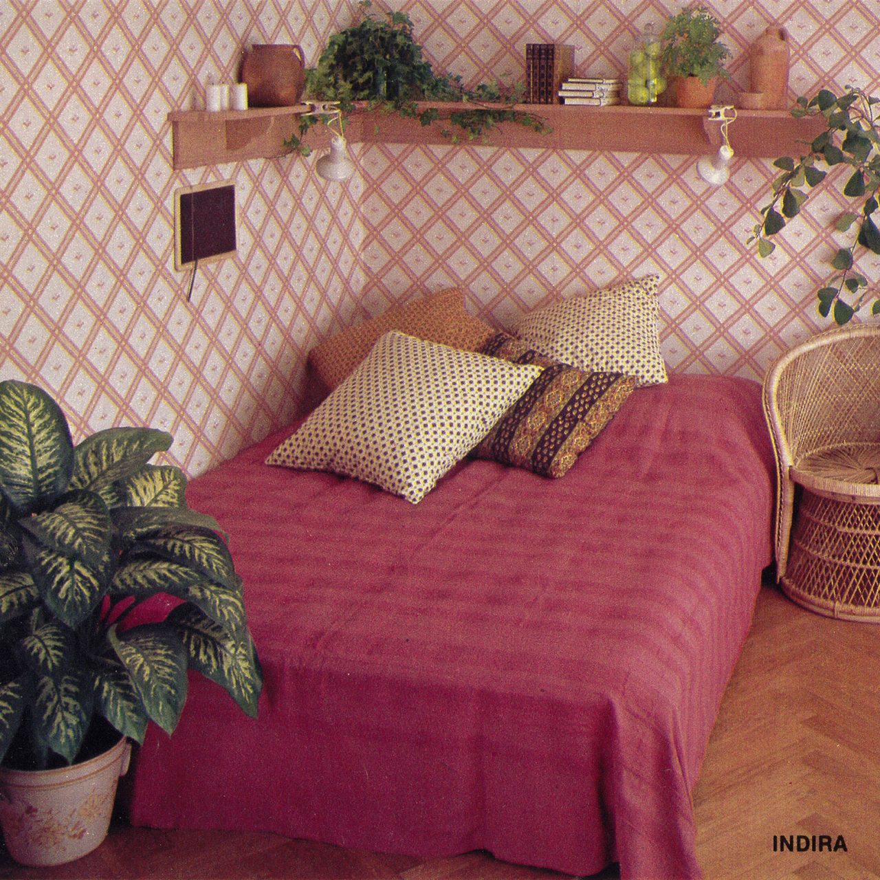 1979 IKEA catalogue bedroom image with a wooden bed, dark pink INDIRA bedspread, and graphic patterned STRAM wallpaper.