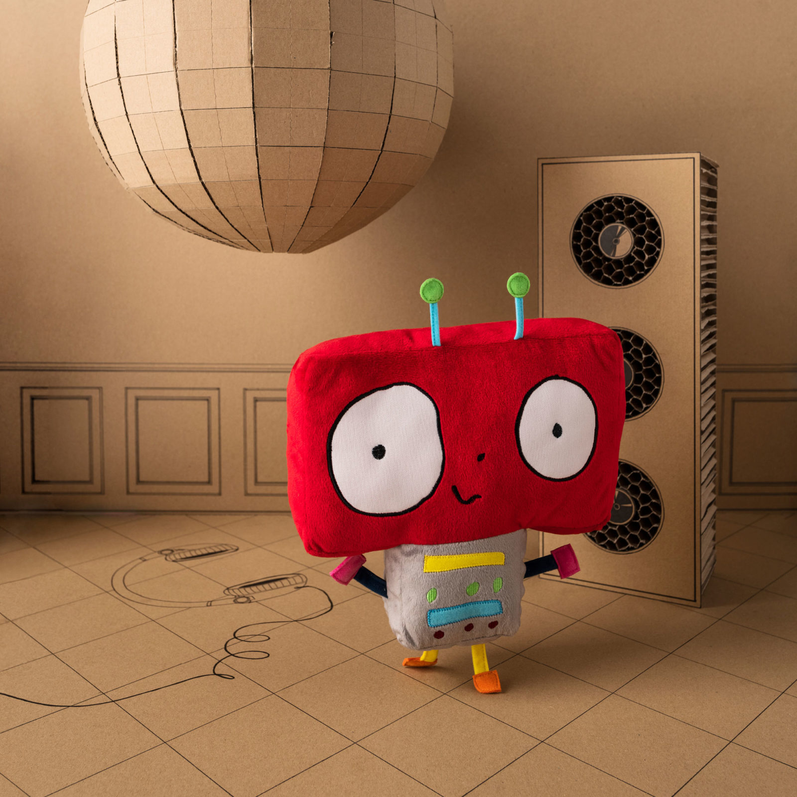 A soft toy robot with broad red head.