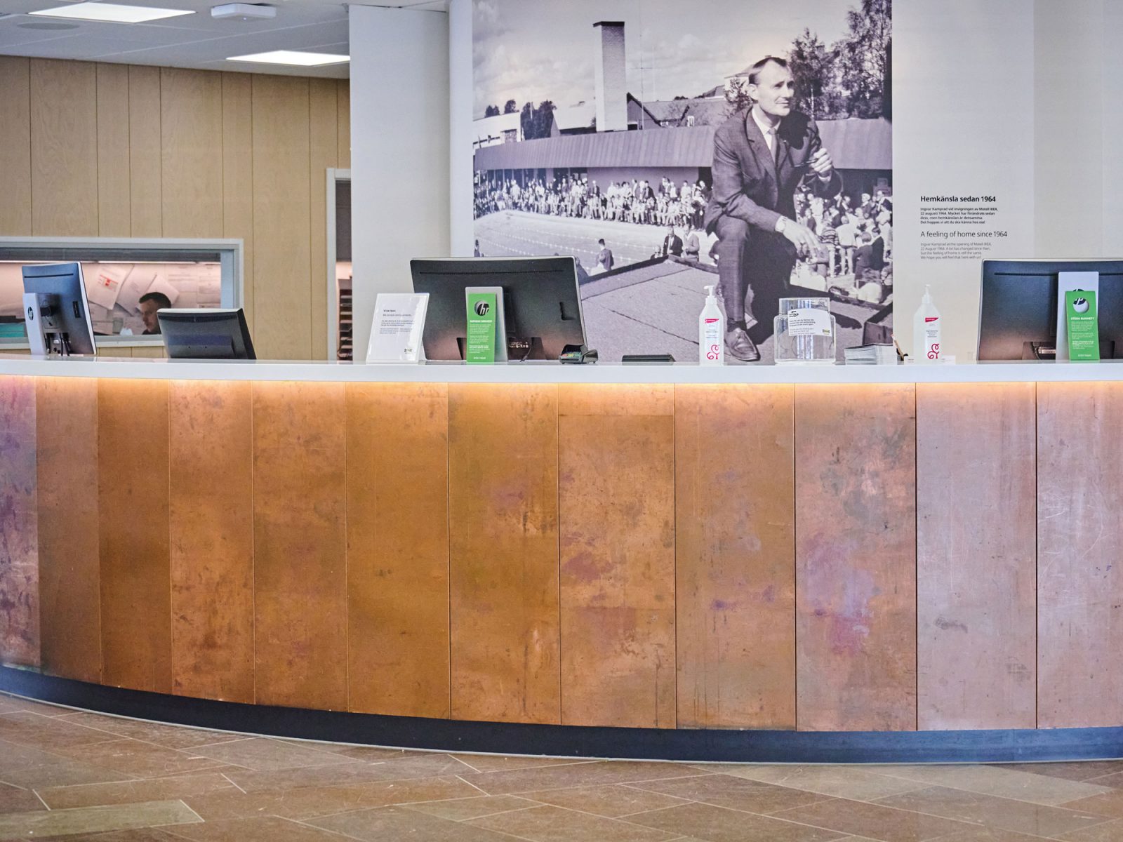 Check-in counter in hotel lobby, counter is covered with copper sheet.