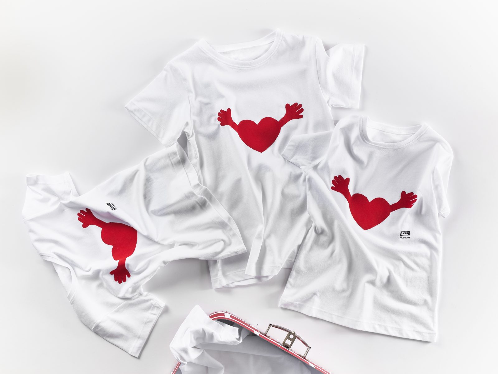 T-shirts with a pillow shaped as red heart with arms.