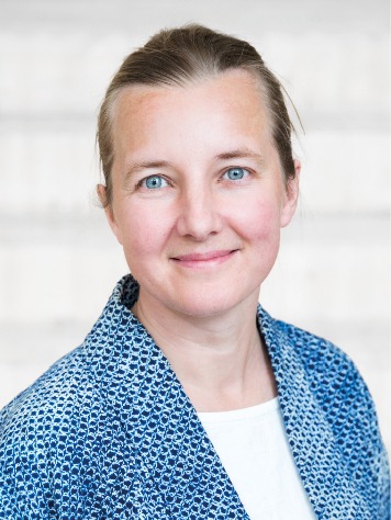 Blonde woman with blue eyes and blue blazer over a white shirt, Linda Worbin.