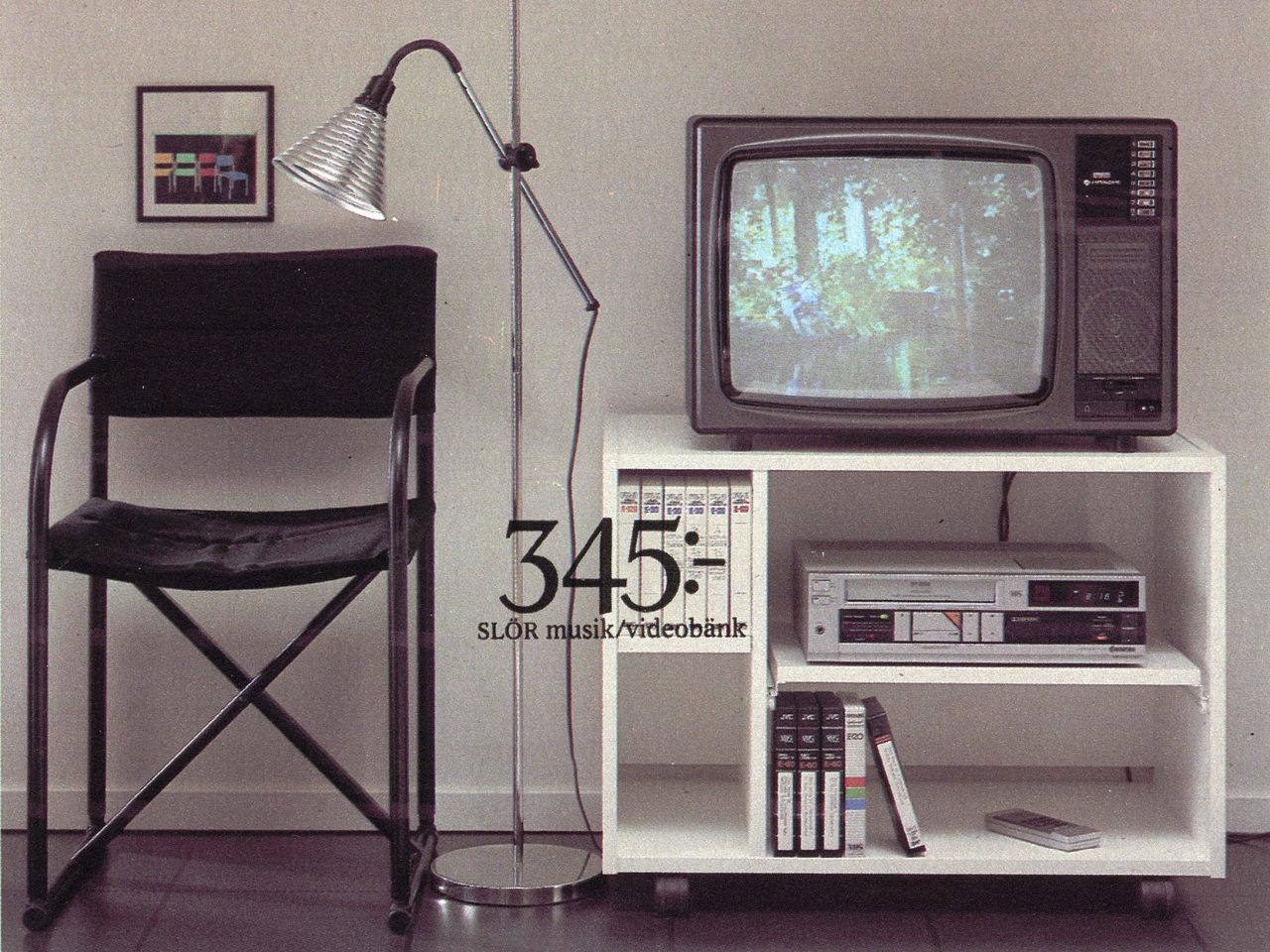 Black director's chair next to a bulky TV on a white lacquered music and video bench in 1980s style.