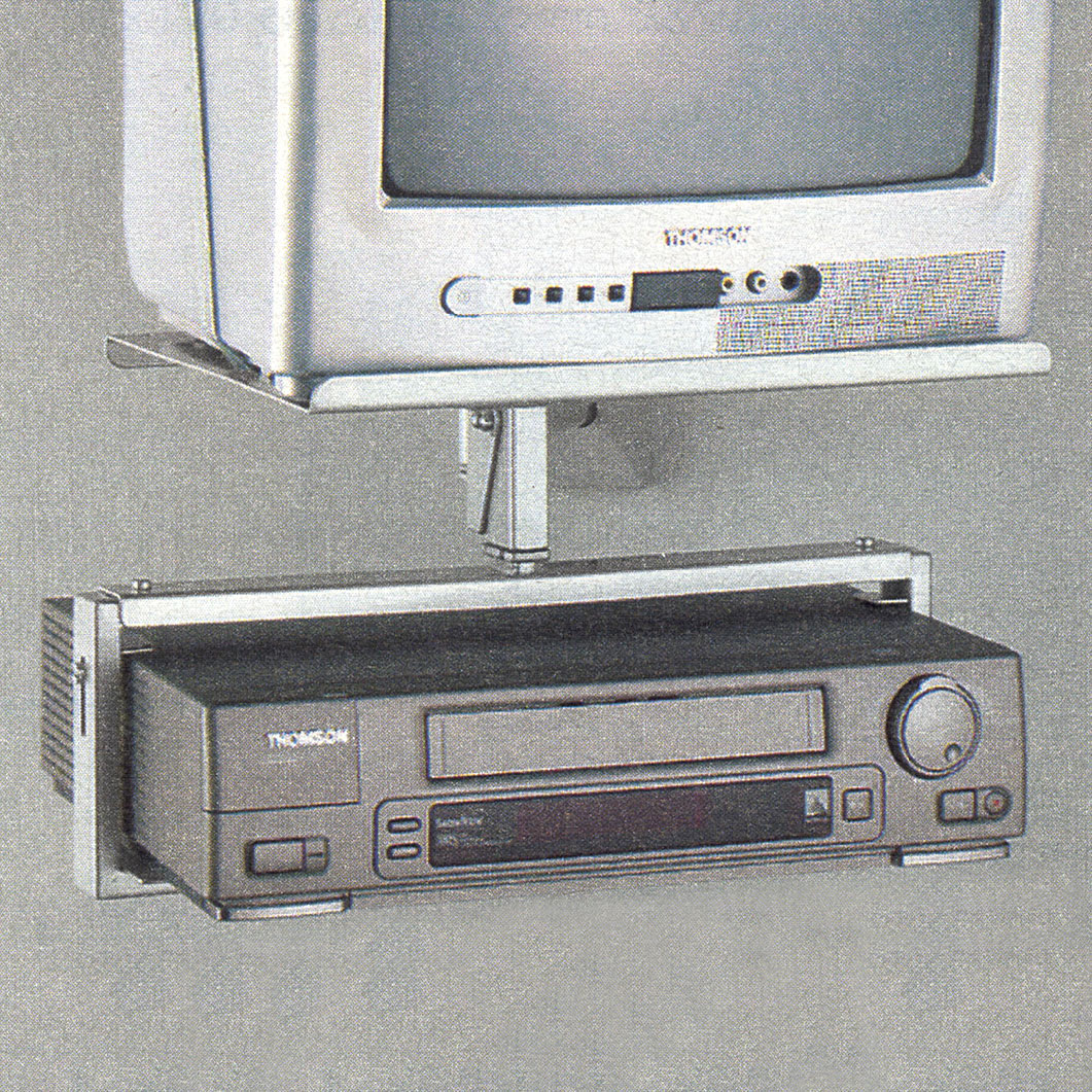 Small bulky TV on a wall-mounted stand with a shelf for a VHS player, OBSERVATÖR.