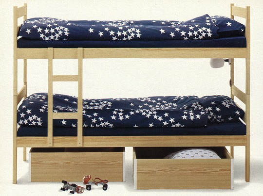 Pine bunk beds made up with star-studded dark blue bed linen.