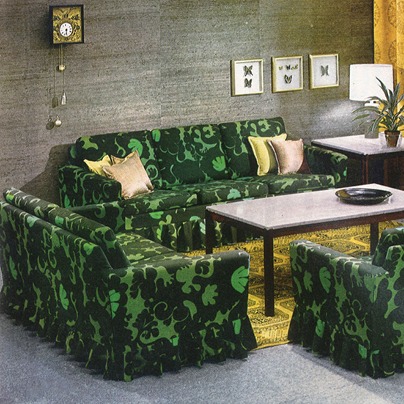1960s style living room with sofa and armchairs in green psychedelic pattern.