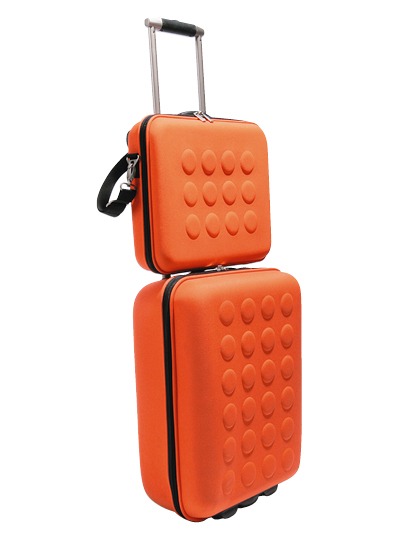 Bright orange suitcase and laptop case.