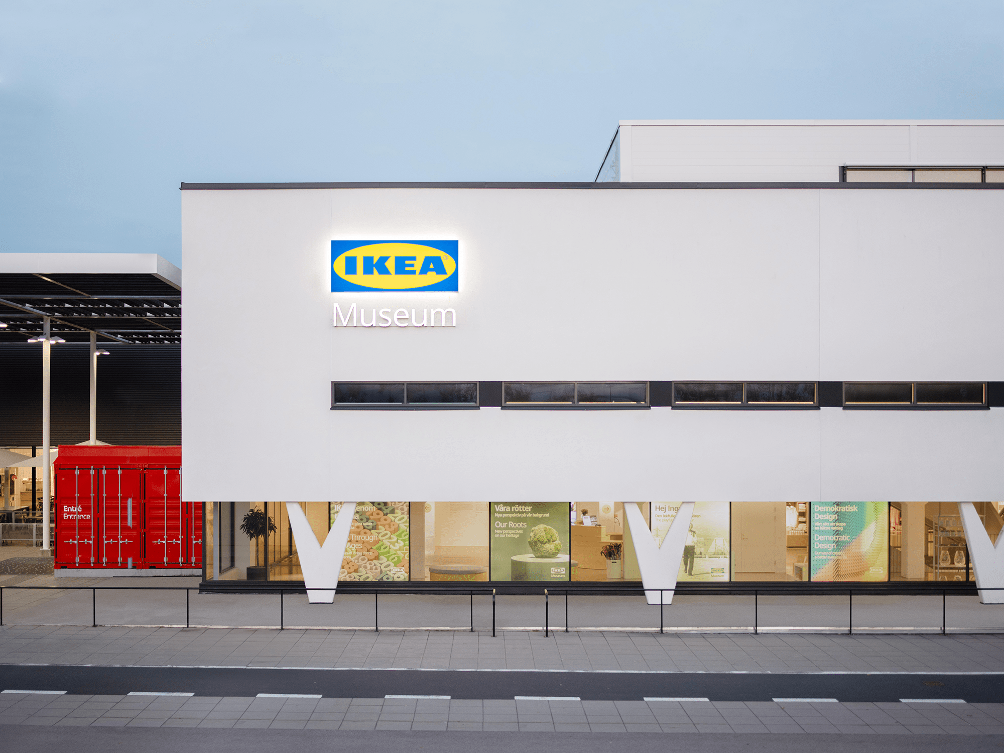 A white building with clean lines and v-shaped pillars, sign on facade says IKEA Museum.