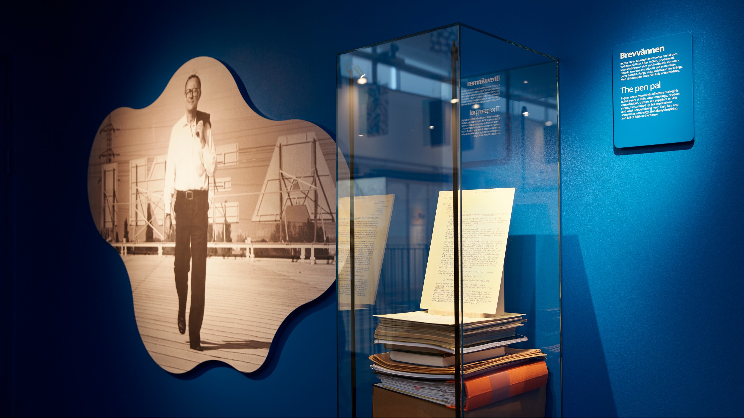 Exhibition with image of Ingvar Kamprad and a display case with letters and documents in glass